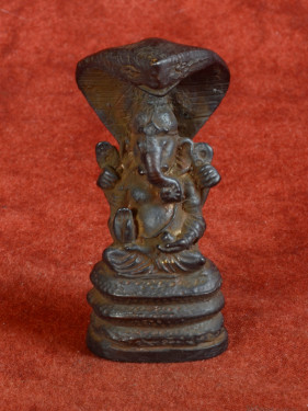 Bronzen Ganesha beschermd door mythische Naga