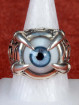 Zilveren draakklauw ring met licht blauw oog
